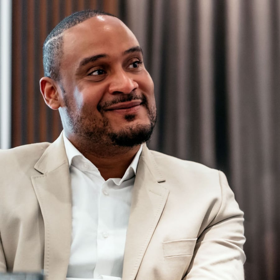 Black Man In Tan Blazer Smiling