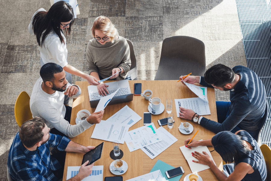 a group of employees from different functions working at a table