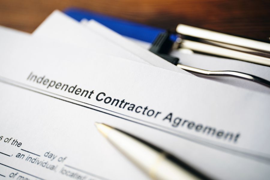 legal document independent contractor agreement on paper close up