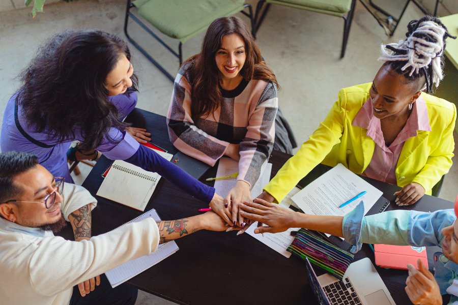 employees from different cultures working together at a table