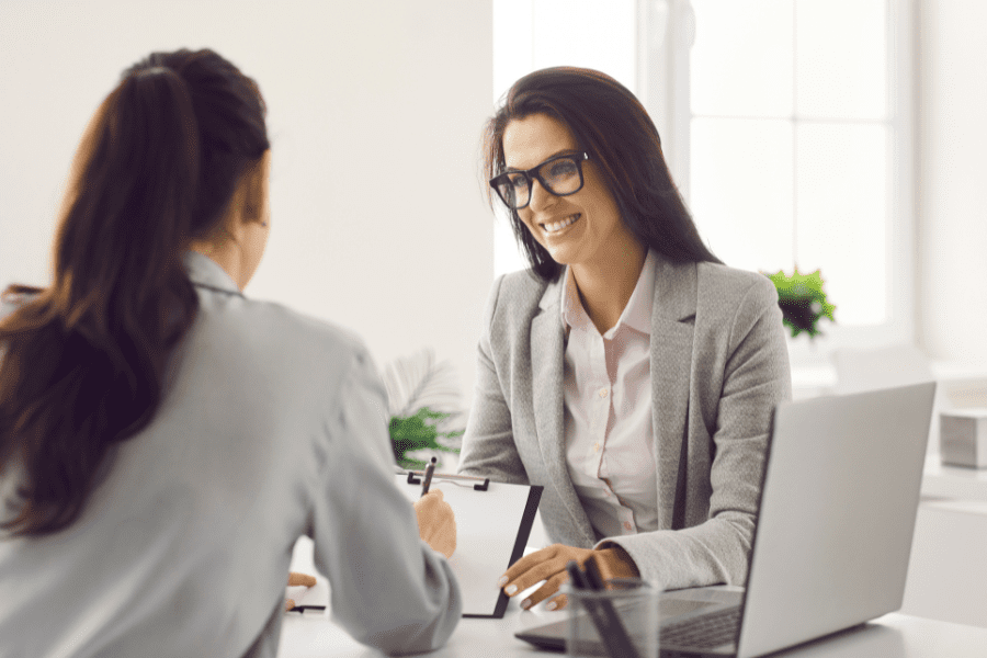 human resources manager and hiring applicant discussing contract