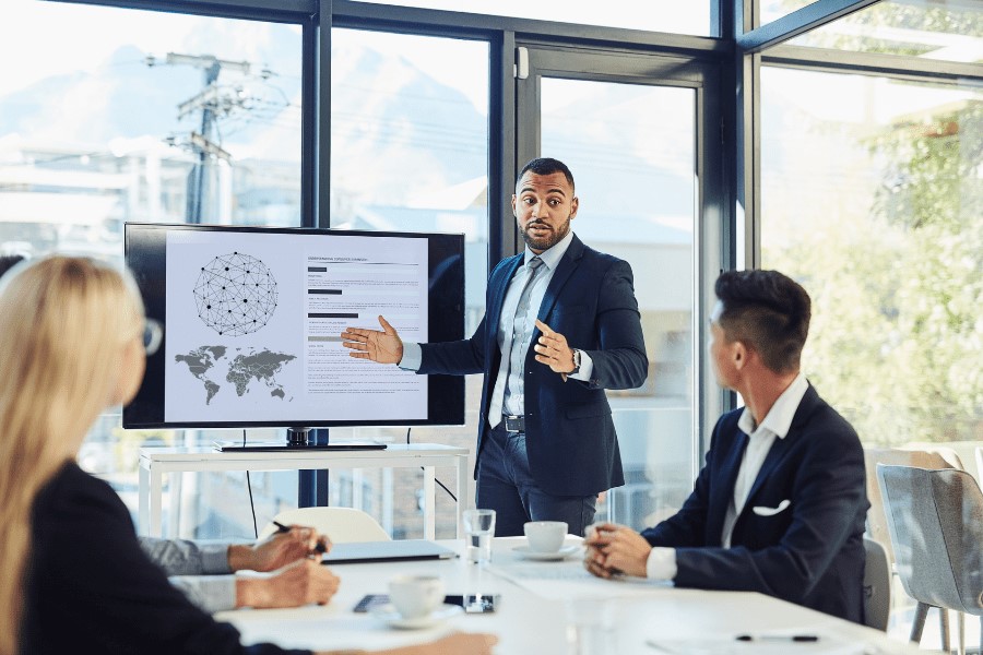 three managers discussing global hiring in an office