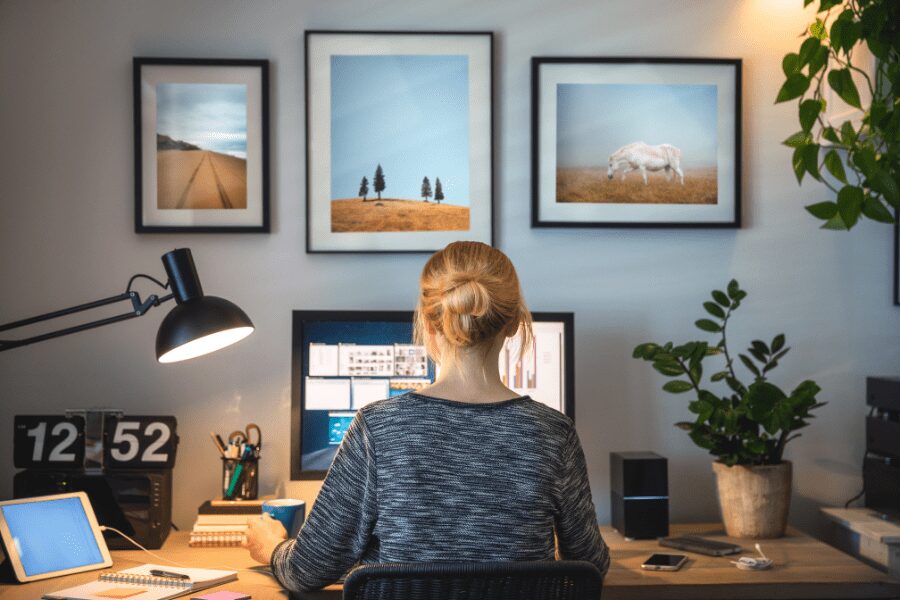 the back of a female employee working from home at her desk